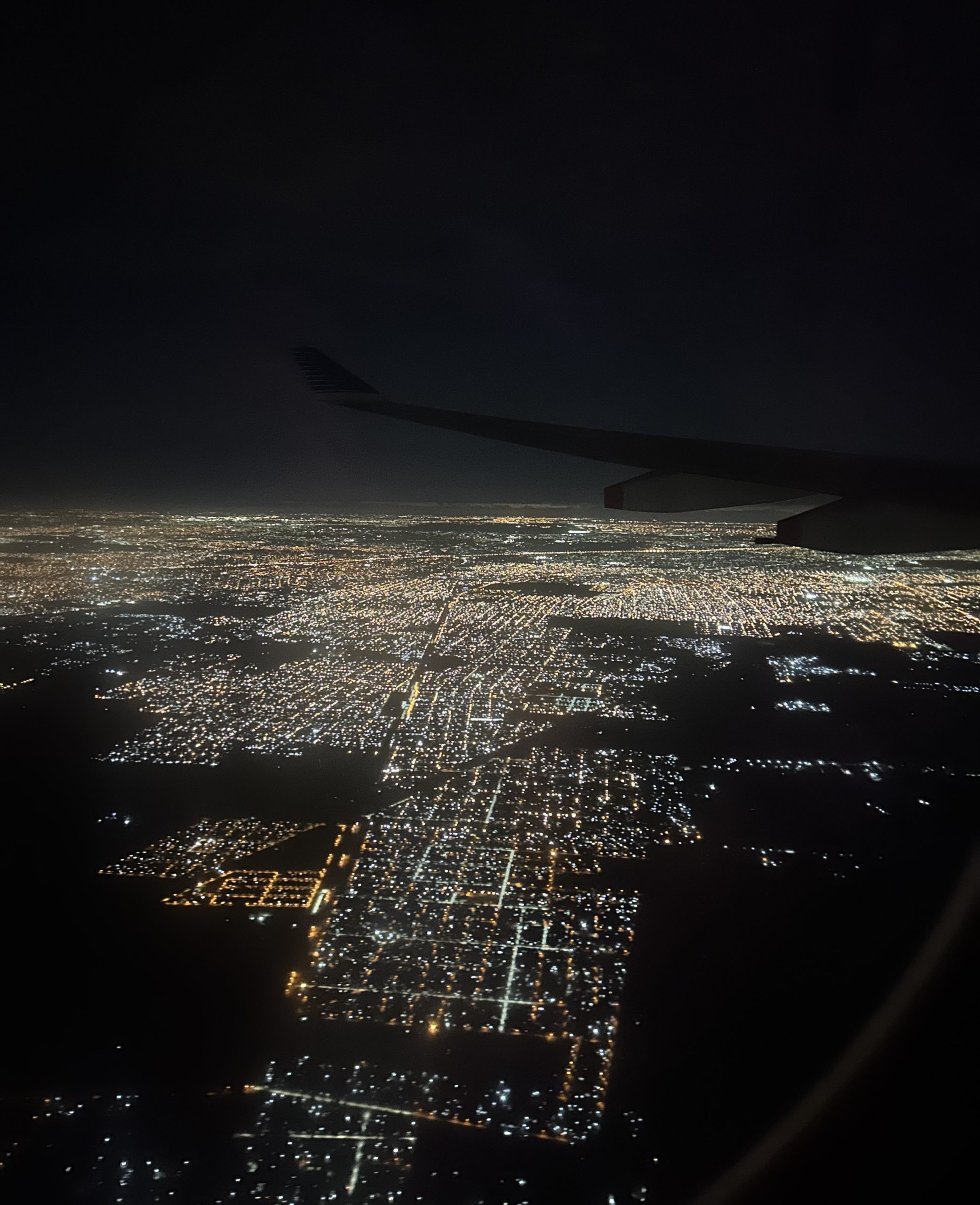the lit up city of Buenos Aires from the airplane window